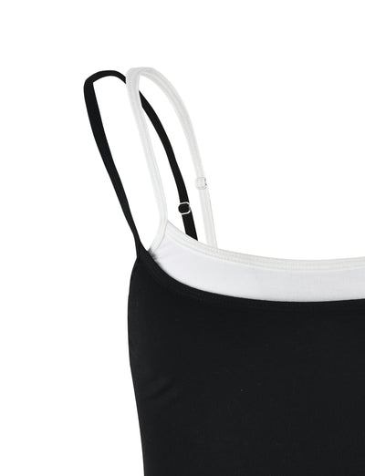 Close-up of the TIGERMIST ADAIR TOP - BLACK with a white inner lining and two thin shoulder straps, one black and one white. The image focuses on the upper portion of the ADAIR TOP, emphasizing the contrasting colors and minimalist design.