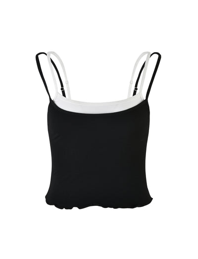 The ADAIR TOP - BLACK from TIGERMIST features a chic spaghetti strap tank top design in black with contrasting white straps and a white trim along the neckline. The top has a soft, fitted design with a slightly ruffled hem and is set against a plain white background.