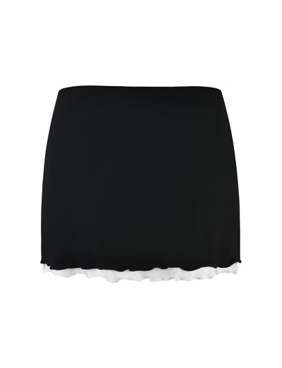 Introducing the ADAIR SKIRT - BLACK from TIGERMIST, a sleek and minimalist black mini skirt. This piece features a slightly flared hem that subtly reveals a white underskirt, creating an elegant layered effect at the bottom.