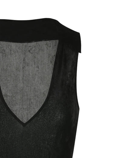 The image shows a close-up of the sleeveless TIGERMIST ABRIL DRESS - BLACK with a V-neck. The semi-transparent mesh fabric allows light to pass through, and the edges are clearly defined. The photo captures the upper left portion of the garment.